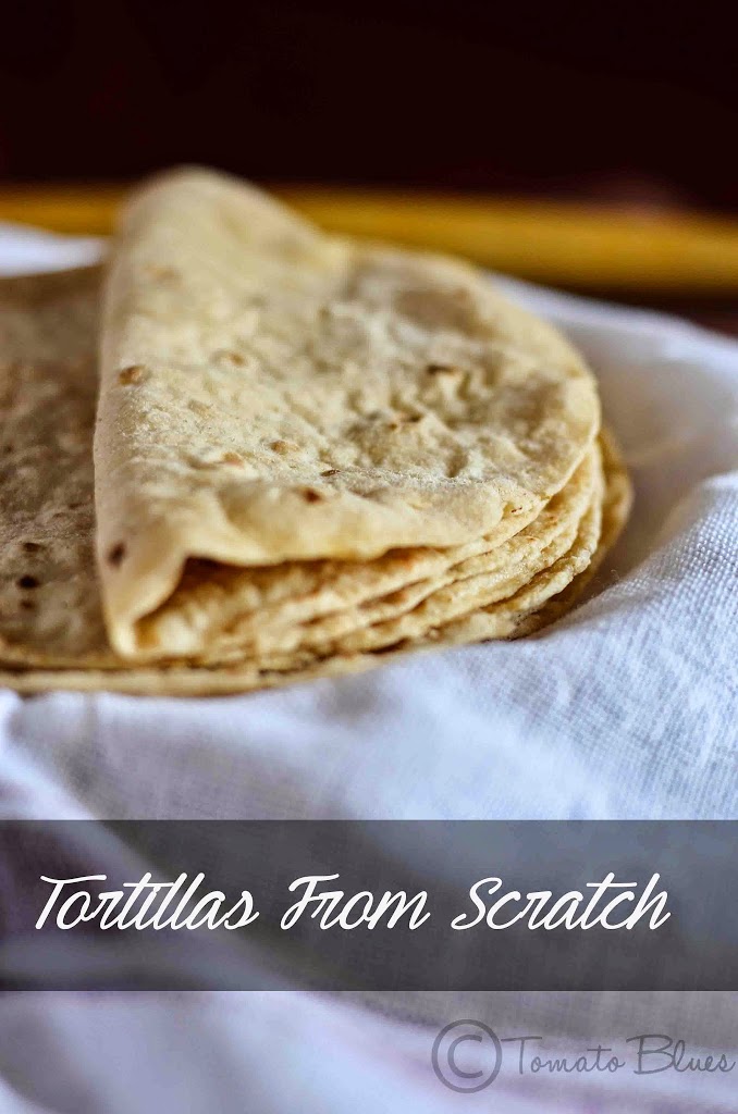 Whole wheat tortilla folded and stacked and placed on a cheesecloth.