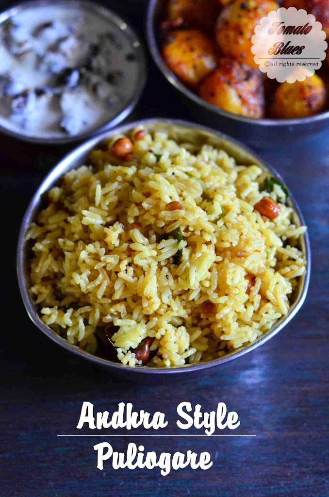 andhra style puliogare presented in a triangular bowl alongside roasted baby potatoes and yogurt sauce