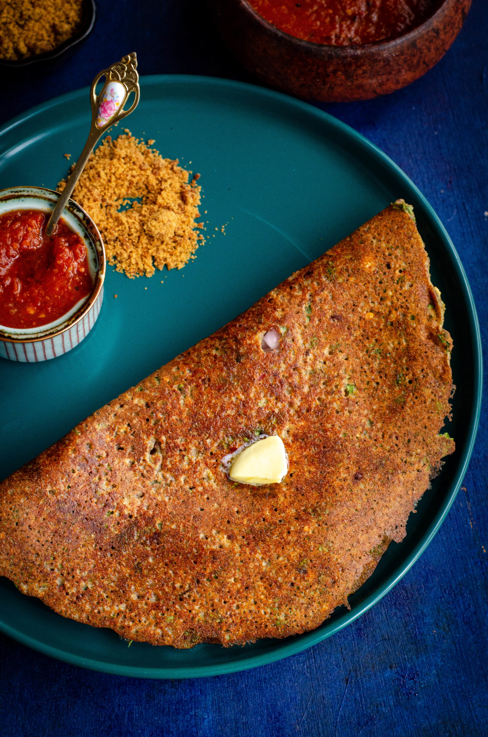 mapillai samba adai served on a turquoise blue plate against a blue backdrop