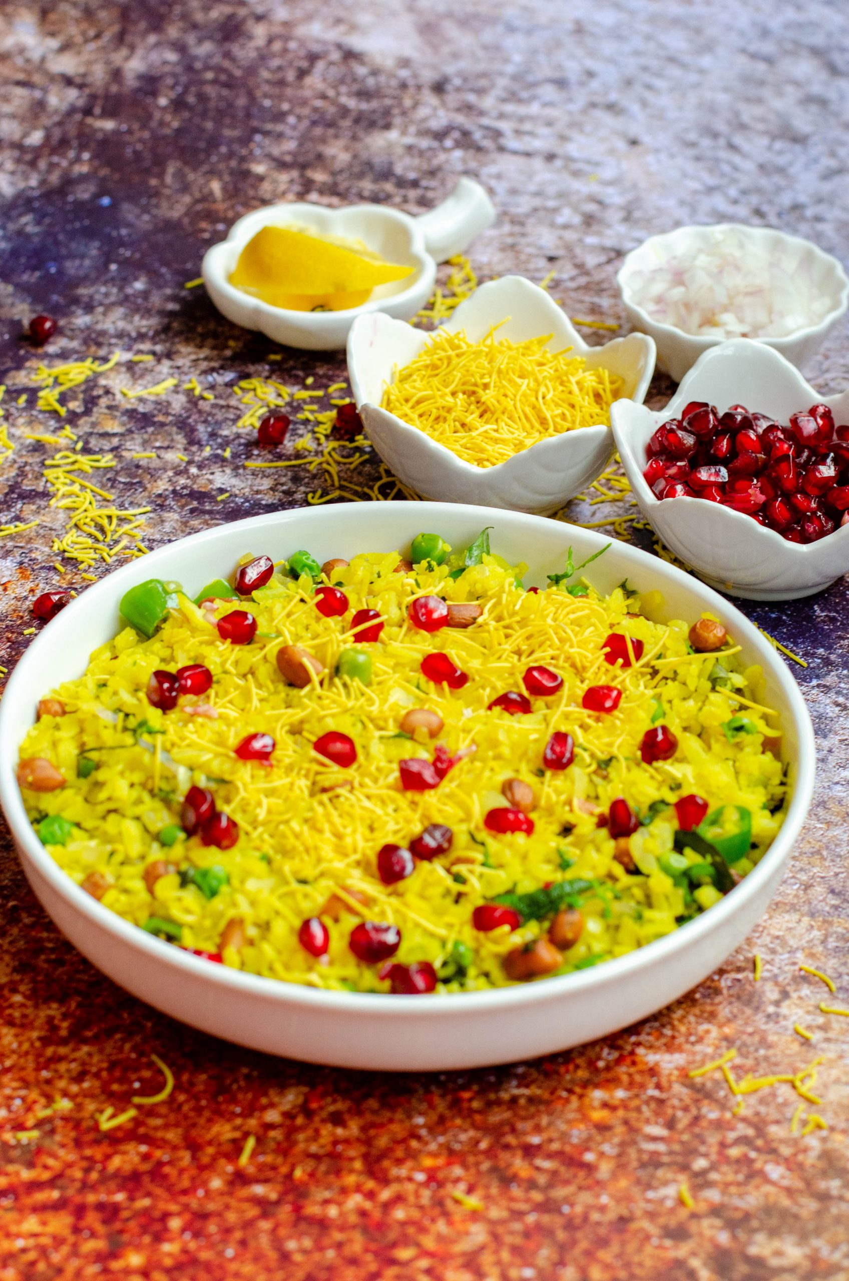 delicious kanda batata poha served in a white bowl with toppings