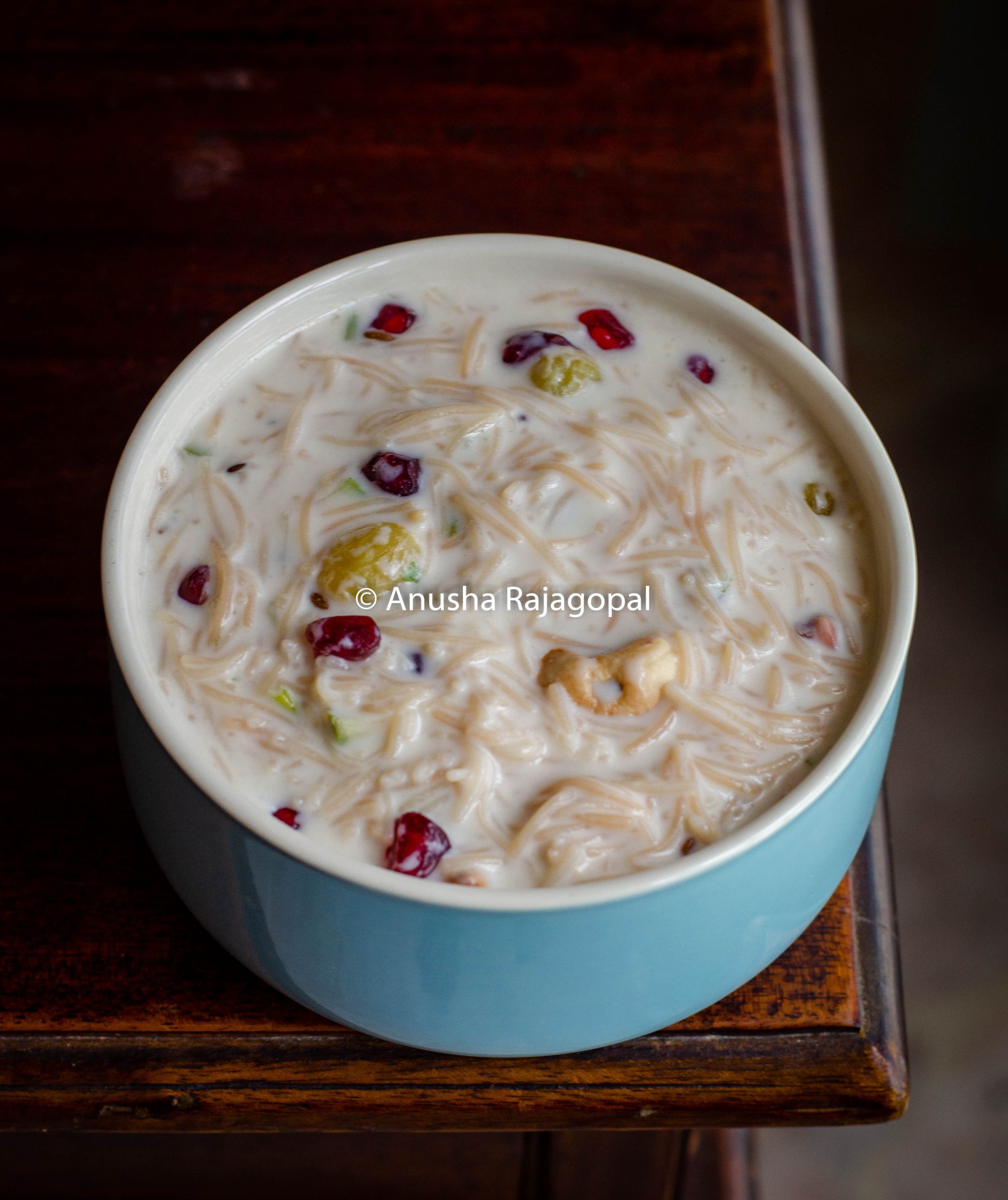 curd semiya served in a blue bowl placed on a wooden table