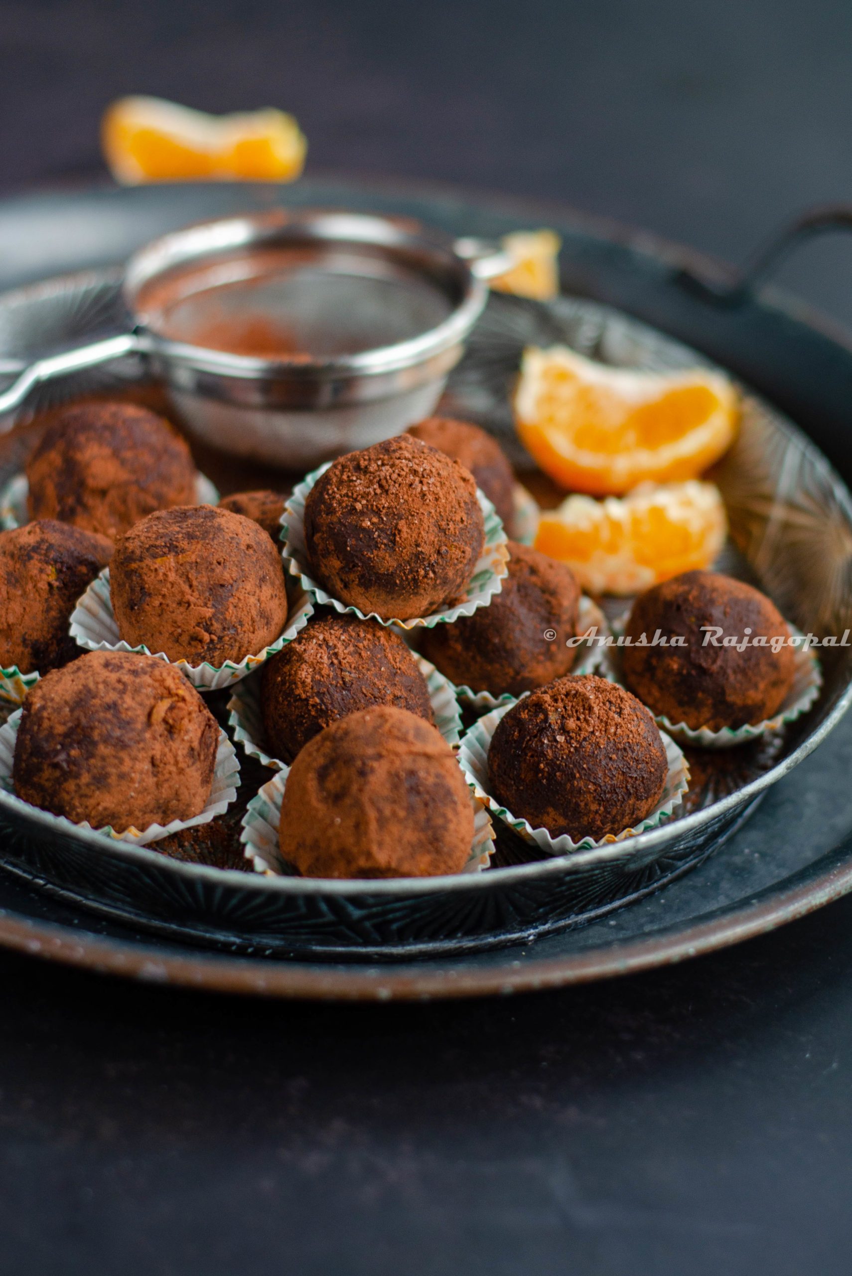 chocolate orange truffles placed on a vintage metal tray