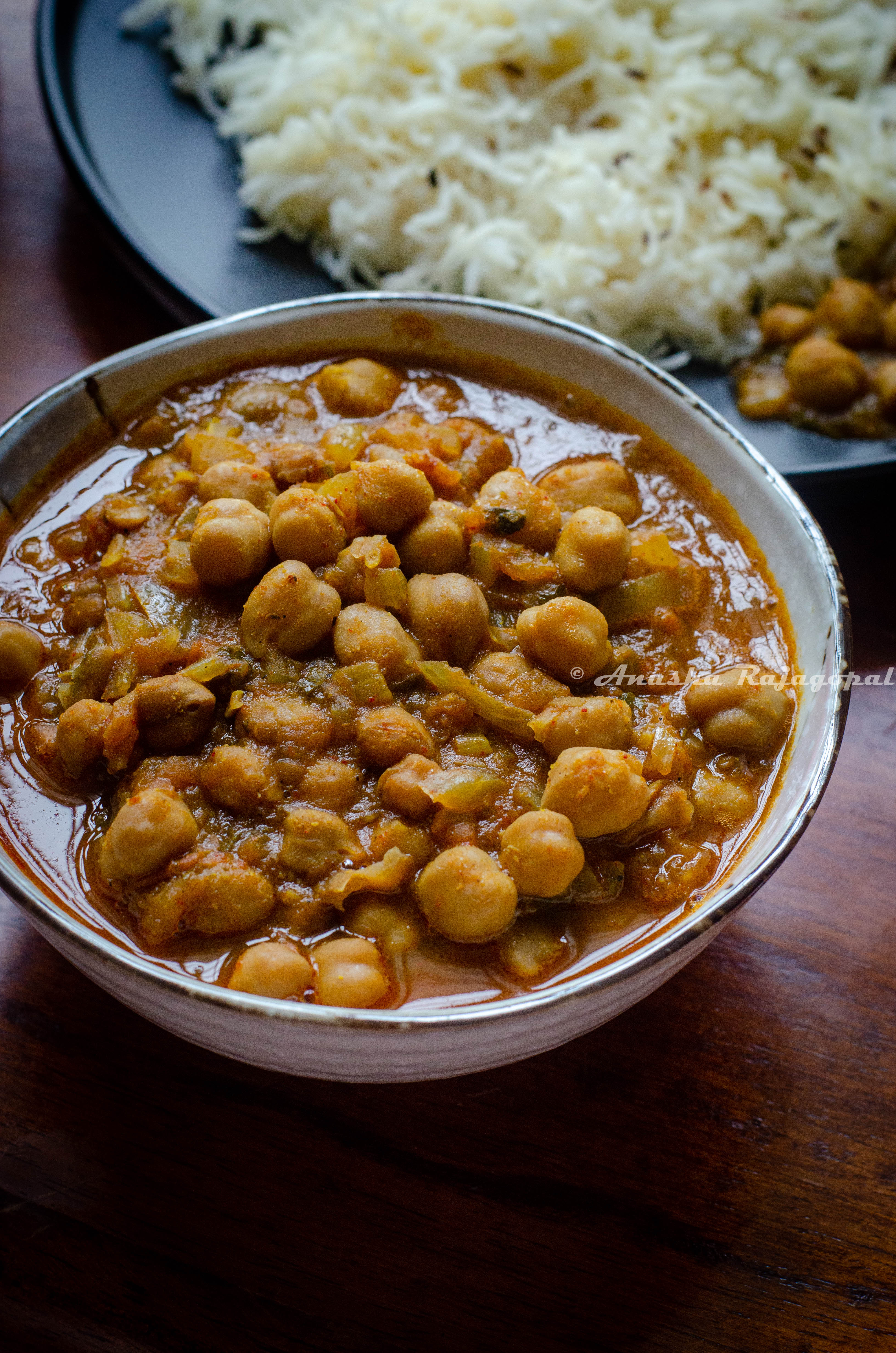 Punjabi chole masala served in a white bowl with steamed rice