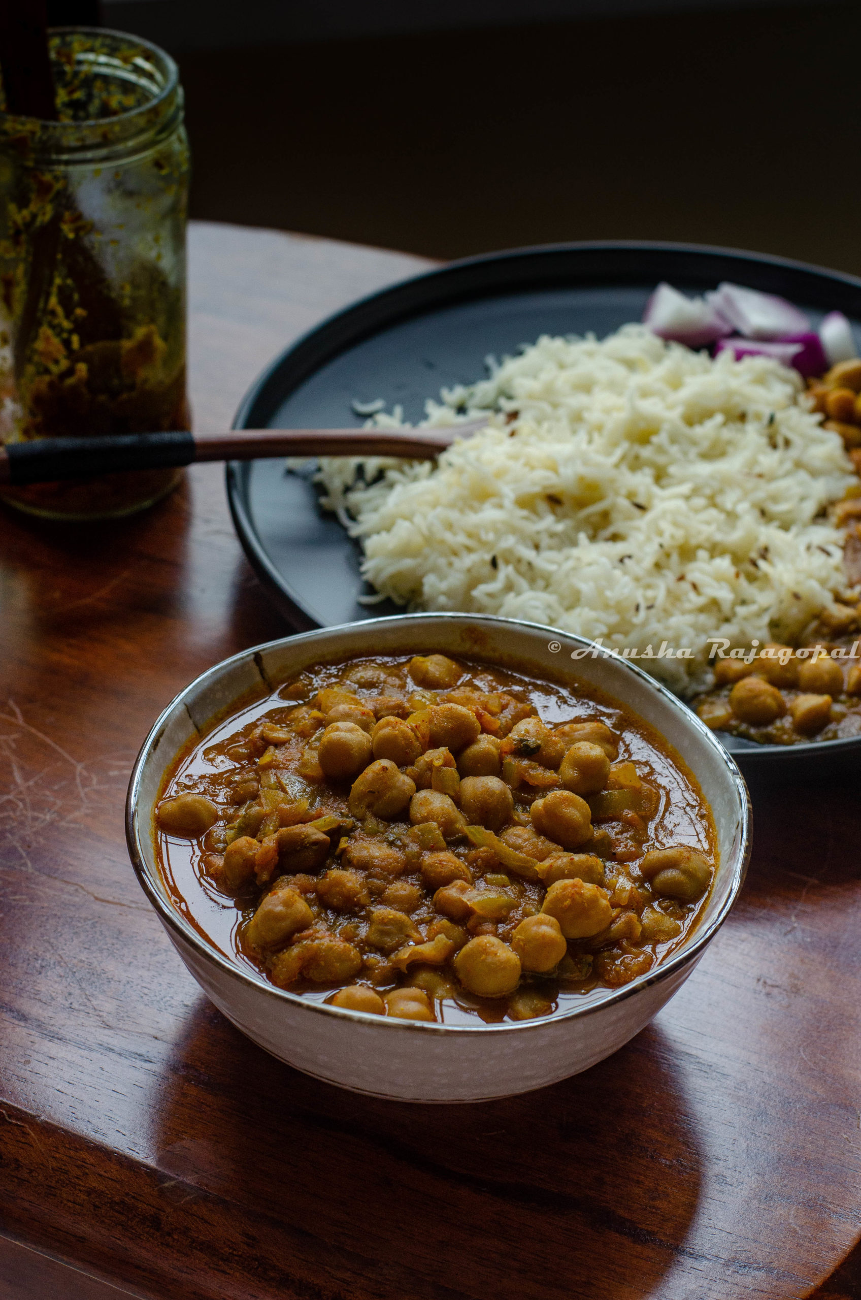 punjabi chole masala served in a beige bowl with steamed rice