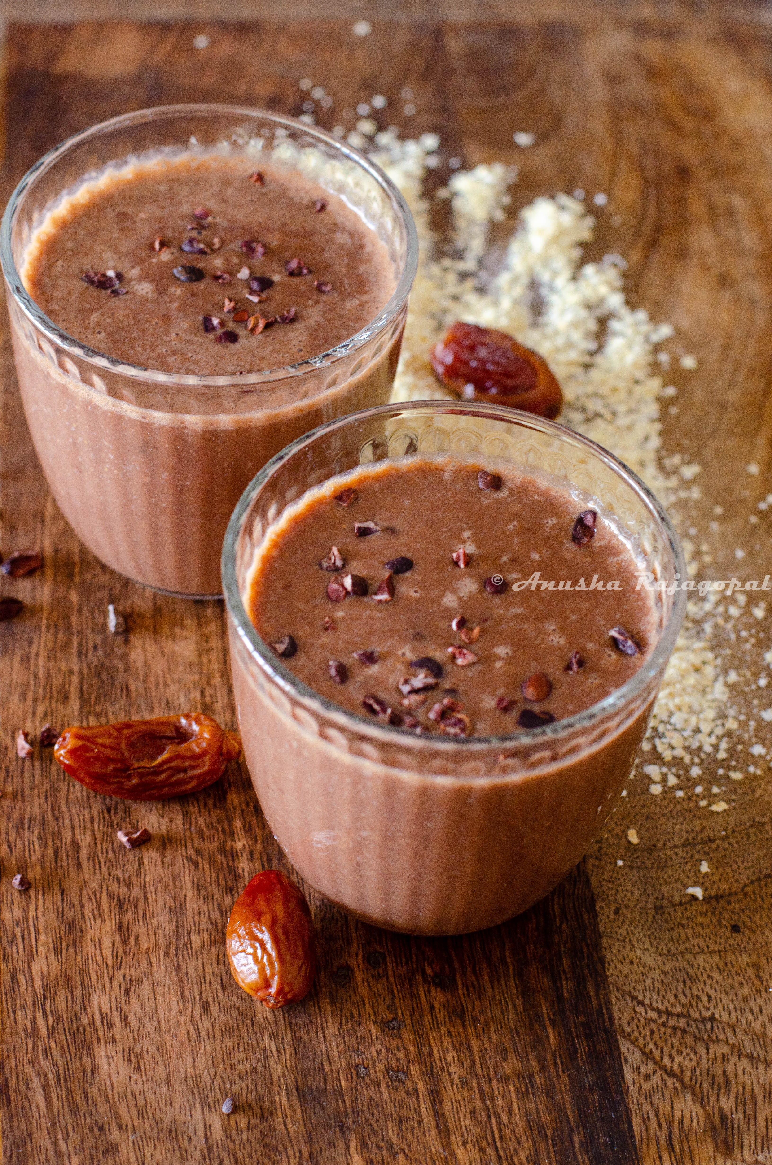 vegan coffee banana smoothie topped with cacao nibs and served in glasses