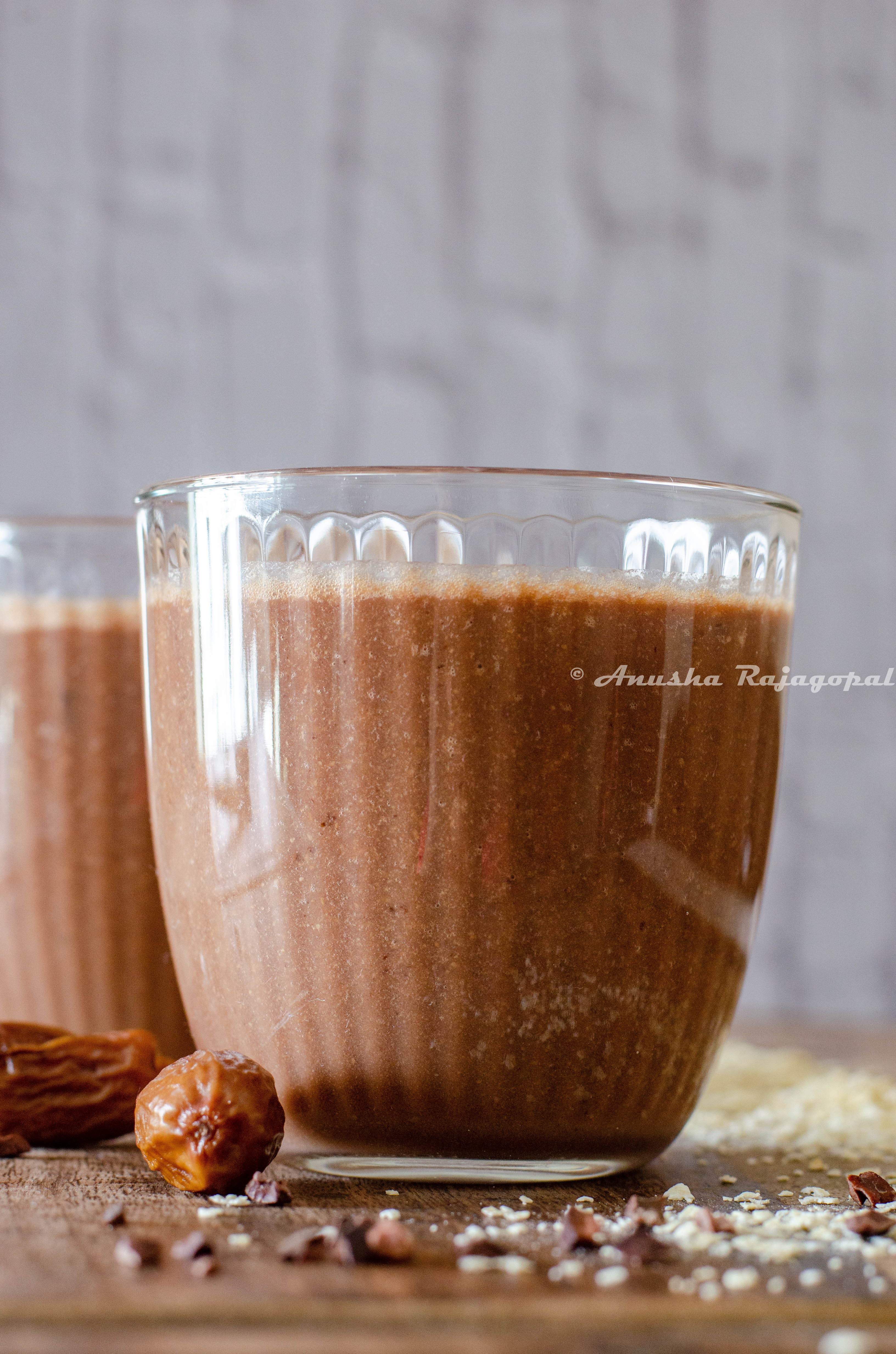 vegan coffee banana smoothie topped with cacao nibs and served in glasses 